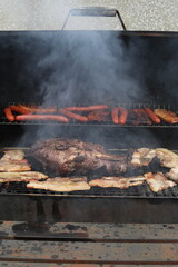Essonne, France. August 2025. A close-up of some grilled meats on a barbecue.