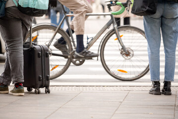 People at the crossing against moving bicyclist