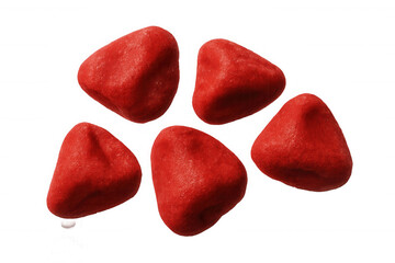 Fototapeta premium Five red pieces of candy falling against a transparent background, creating a vibrant and tempting visual