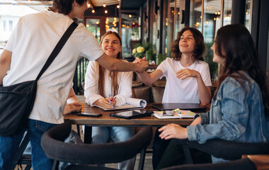 Group of young friends are in the cafe restaurant