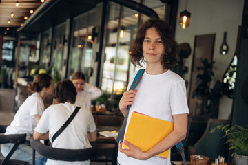 Standing in front of people. Group of young friends are in the cafe restaurant