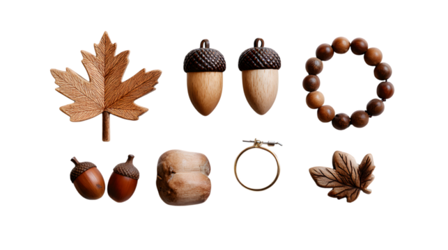 Natural autumn elements like carved maple leaves acorns wooden beads and a bracelet create a warm organic collection isolated on white background