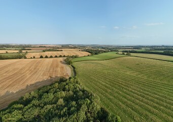 Aerial drone shot of rural agriculture landscape fields, golden harvest and green fields in England UK Leicestershire 