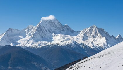A majestic mountain range covered in snow under a clear blue sky on a bright sunny day in a winter landscape © SSCreations
