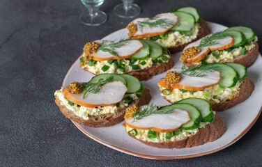 Homemade sandwiches with chicken balyk, cucumber, mustard and green onion