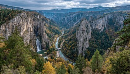 Autumnal gorge with waterfall