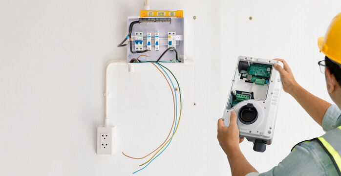 Electrician installing home EV charging station