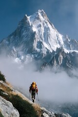 Solo Climber Ascends Majestic Snow Capped Mountain Through Wispy Clouds