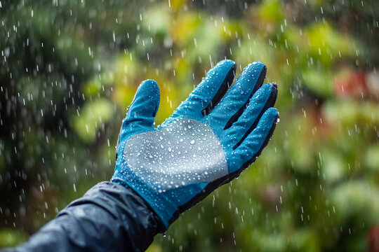 Gloved hand reaching out in the rain with droplets Generative AI - Powered by Adobe