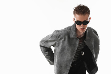 Obraz premium Handsome young man wearing stylish jacket and sunglasses on white background