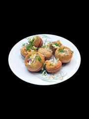 Deliciously prepared savory appetizers garnished with fresh herbs on a white plate