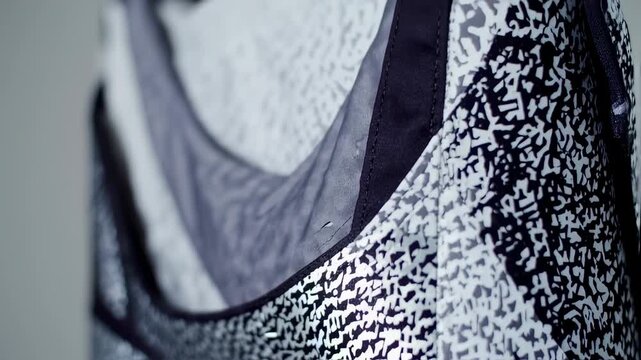 Dynamic Close-Up of Modern Monochrome Sportswear Fabric with Abstract Black and White Pattern
