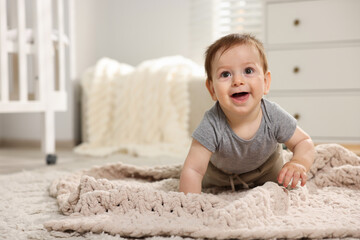 Fototapeta premium Cute little baby crawling on floor in room. Space for text