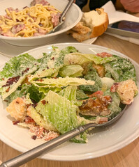Crisp Caesar salad whispers tales of gastronomic artistry, perfect for whimsical Picnics in the Park Day, midday Italian feasts