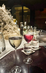 Shimmering cocktail glasses beckon in a dim speakeasy, perfect for an unorthodox celebration of Beaujolais Nouveau Day or International Gin and Tonic Day