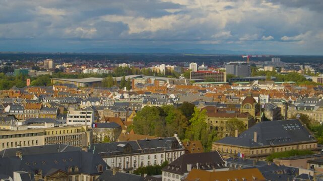 Panning shot of Strasbourg aerial view, with old town and newer neighborhoods visible. Strasbourg cityscape of a stormy overcast day.  Aerial view of a European city under cloudy skies