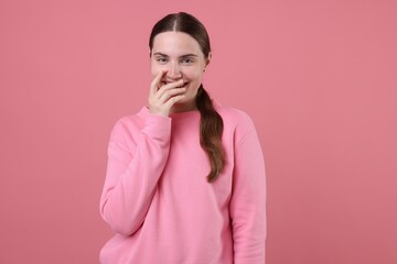 Obraz premium Beautiful woman laughing on pink background. Positive emotion
