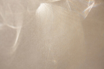 Beige background with delicate textures,sun glare and shadows with pearlescent linear elements and decor with light beam overlay effect and bokeh for abstract design. Modern style concept for posters.