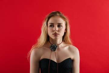 Fototapeta premium Beautiful woman in stylish necklace on red background