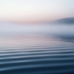 Gentle mist over a reflective water surface creating soft ripples and muted gradients serene and isolated