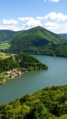 Fototapeta premium Panoramic view of a lake nestled amongst lush hills