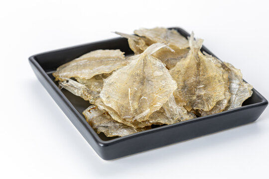 Dried sweet fish in a black plate. Scientific name is Parambassis siamensis. It is a type of food preservation.