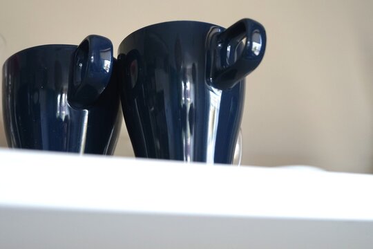 Two blue mugs cups on the shelf together she he mr and mrs wife husband love family couple coffee 