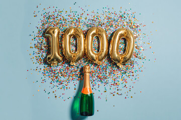 Celebrating a 1000 milestone achievement with a bottle of sparkling wine and vibrant confetti