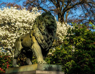 Lion statue in park with flowers