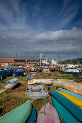 Colorful boats on a sunny day. View of the quay on the River Deben in the historic town of Woodbridge in Suffolk, UK.