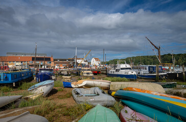 Colorful boats on a sunny day. View of the quay on the River Deben in the historic town of Woodbridge in Suffolk, UK.