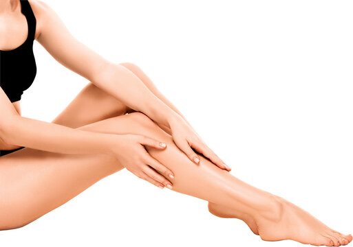 Female legs in black sportswear sitting and touching shin isolated on transparent. Concept of beauty, self-care, fitness, relaxation, and body awareness with elegant feminine style.