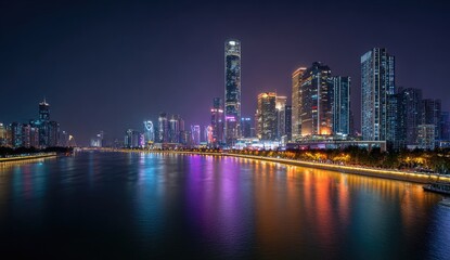 Fototapeta premium Illuminated city skyline reflecting on a river at night