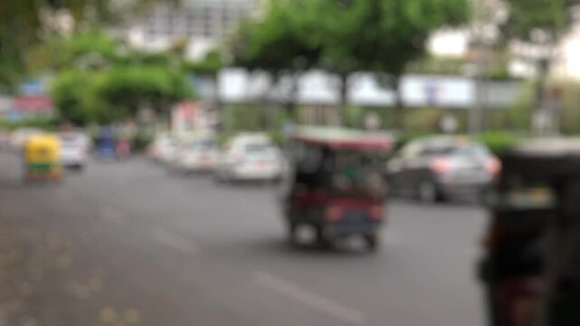 Bokeh view of road traffic and the office buildings of Dlf Cyberhub Cybercity Gurgaon Gurugram, New Delhi, India. Blurred background footage.