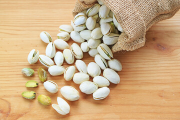 Heap of Roasted Pistachio Scattered from Burlap Bag, a Fruit (Drupe) High in Protein and Good for Overall Health