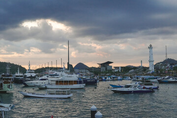 Beautiful seascape of Labuan Bajo with a collection of traditional boats Pinisi schooner sailing.