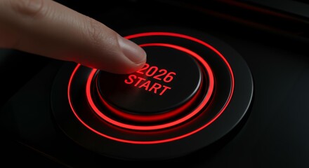 Close-up finger pressing illuminated red 2026 start button with glowing concentric rings for new year launch activation