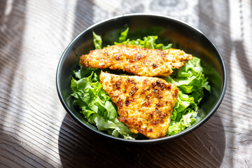 fried chicken with salad vegetables close up