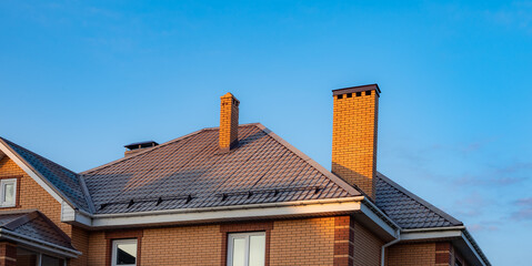 Elegant House with Modern Roof Tiles and Chimney View