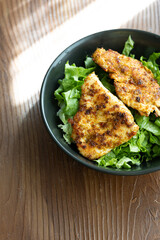 fried chicken with salad vegetables close up