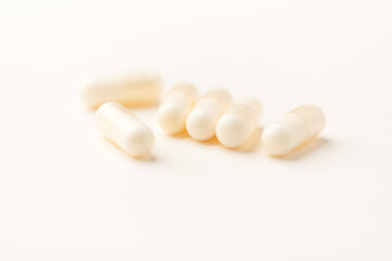 Creatine tablets on paper background. Soft focus. Close up. Copy space.	