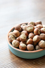 Fresh Turkish hazelnuts in shell in bowl in close-up