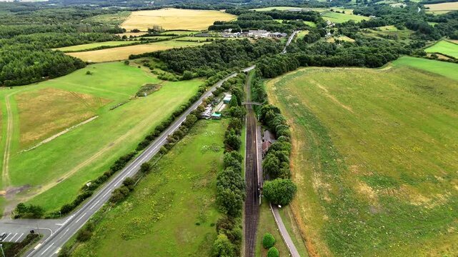 Durham UK: 22nd July 2025: Drone view of Tanfield Railway in County Durham with main road running adjacent. Green fields during summer