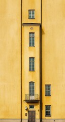 A tall, mustard yellow building facade