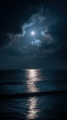 Oceanic expanse beneath a full moon shrouded by clouds, shimmering light on the water