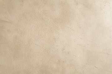 Naklejka premium Beige stucco texture has soft lighting, creates neutral backdrop. Ideal for product staging, branding, graphic design.