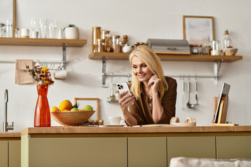 Senior woman enjoying a moment while browsing on her smartphone in a cozy kitchen