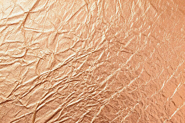 Fototapeta premium Copper crumpled texture reflects light, offering grunge background for digital design, product display, or branding.