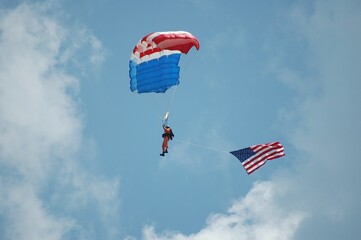 sky diver with American flag hanging