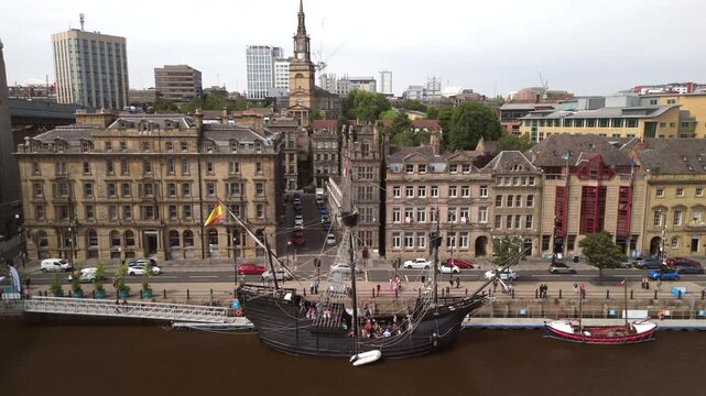 Newcastle upon Tyne: 24th July 2025: Nao Victoria ship docked at Tyne Quayside with city backdrop and visitors exploring the historic vessel. Drone footage